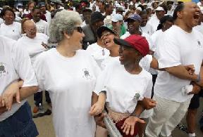 Clariece Paulk, from left, whose husband is the founding pastor of the Cathedral at Chapel Hill, Marlena Costa and Mary Hughes, both church members, interact during a rally following the Pro Love March.